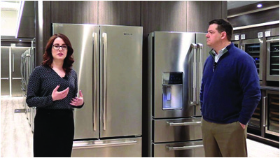 A salesperson describing a fridge to her customer: describing a machine part by part is a real skill people use at work every day.