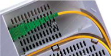 The fibre's connector plugged into the socket of a router.