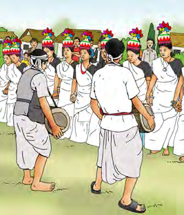 Tharu dancers in white, drumming and performing their traditional dance.