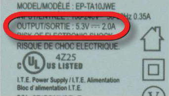 The OUTPUT line on a mobile charger's label shows the 5.3 V it gives to the phone, far less than the 220 V it takes from the socket.