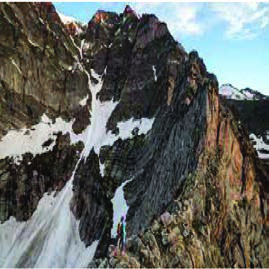 A high mountain with only thin streaks of snow left in its gullies: warming strips snow and ice from peaks that were once white.