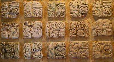Maya hieroglyphs carved in stone. Each carved block is a picture that stands for a word, syllable or sound.