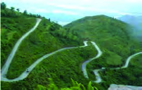 A winding mountain road: the bends lengthen the road and so make the slope gentler, letting the engine's force pull the vehicle uphill easily.