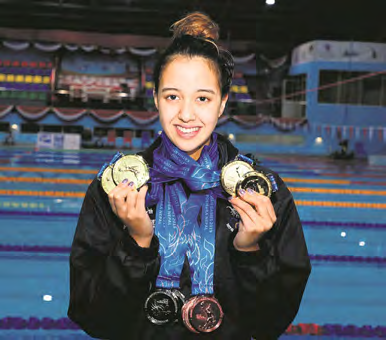 Gaurika Singh at the poolside with her medals from the 13th South Asian Games.