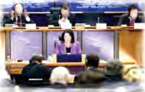 A speaker at the podium opens an international conference. A formal speech like this is written to be heard by a room full of experts.