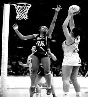 The Goal Keeper stretches up to stop an opponent's shot from reaching the ring.