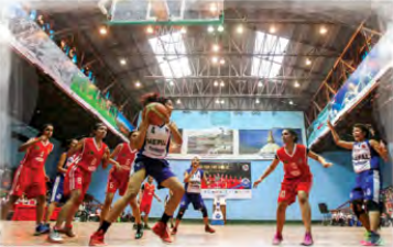 Basketball: players dribble the ball and shoot it into a raised hoop.