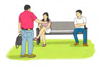 A man greets two people resting on a park bench.