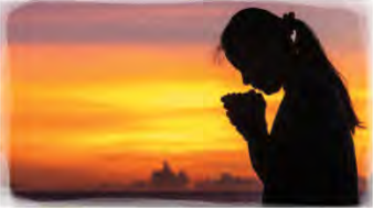 A girl praying at sunset, serving through prayer.