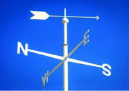 A wind vane above the compass letters N, E, S and W; the arrow swings to show where the wind is blowing from.