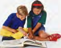 Two friends looking at pictures together: pointing out who is who is where relative clauses come naturally