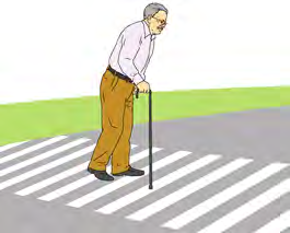 An old man with a walking stick crosses the road at the zebra crossing.
