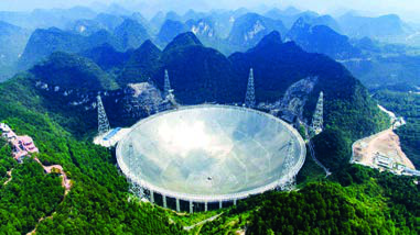 A giant radio telescope built into a ring of hills. Instead of looking at the sky, it listens to it.