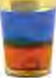 Liquids of different densities settle in layers in one glass, with the densest at the bottom.