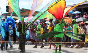 Dancers in huge, colourful costumes at Crop Over in Barbados.