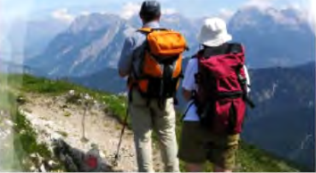 Trekkers looking out over snowy peaks: leisure that rests the mind and widens experience.