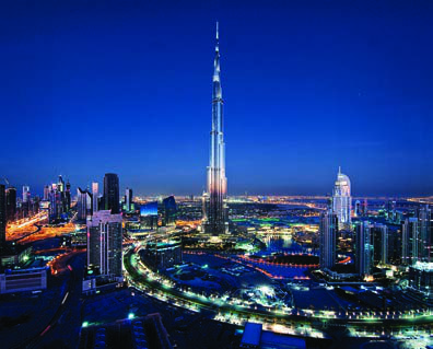 The Burj Khalifa towering over Dubai at night, a modern city built to amaze its visitors.