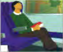 A man reading in a reclining seat by a window
