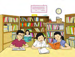 Students reading silently at the library tables. This is the right way to behave in a library.
