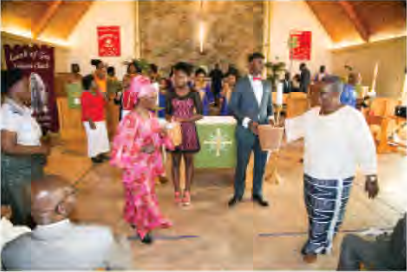 Liberians give thanks at a church service before the family feast.