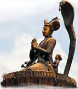 The statue of Pratap Malla on its stone pillar in Hanuman Dhoka Durbar Square, the king seated with his hands joined in prayer beneath the hood of a cobra.
