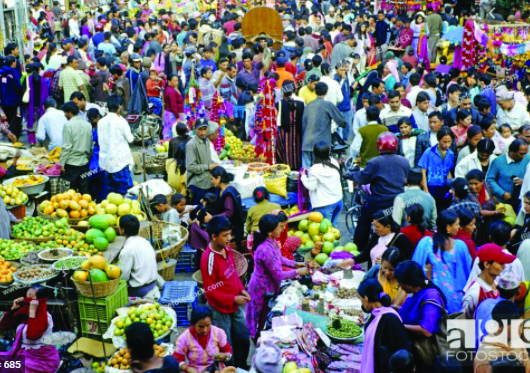 A market just before a festival: the whole town seems to be there, and every buyer has things to buy.