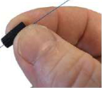 The outer covering is removed and the bare fibre is threaded into its connector.