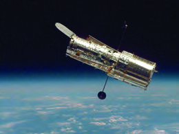 The Hubble Space Telescope in its orbit above the Earth