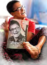 Jhamak Ghimire holding a copy of her autobiography