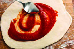 Step 5: Spread the sauce over the base.
