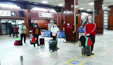 Travellers with luggage in a public building: strangers here must ask for directions and help politely.