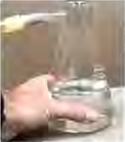 With the plunger pulled out, the pressure falls and the warm water boils.