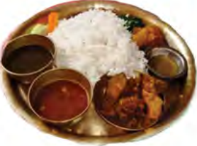 Dal-bhat: rice, lentil soup, curry and pickle on one plate