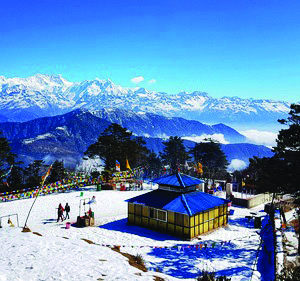 A snow covered viewpoint with the high Himalaya behind it. Buses, cable cars and trekking trails can all be part of your answer to the question, how would you get there?
