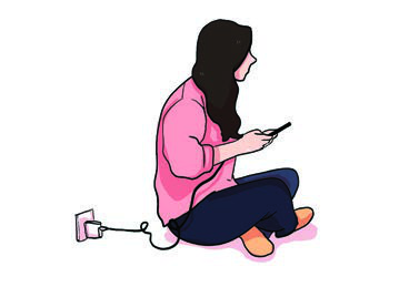 A girl using her phone while it is still plugged in and charging, the exact habit the reading warns against.