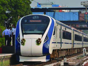 An ordinary electric express train at a station, the slower of the two trains being compared.
