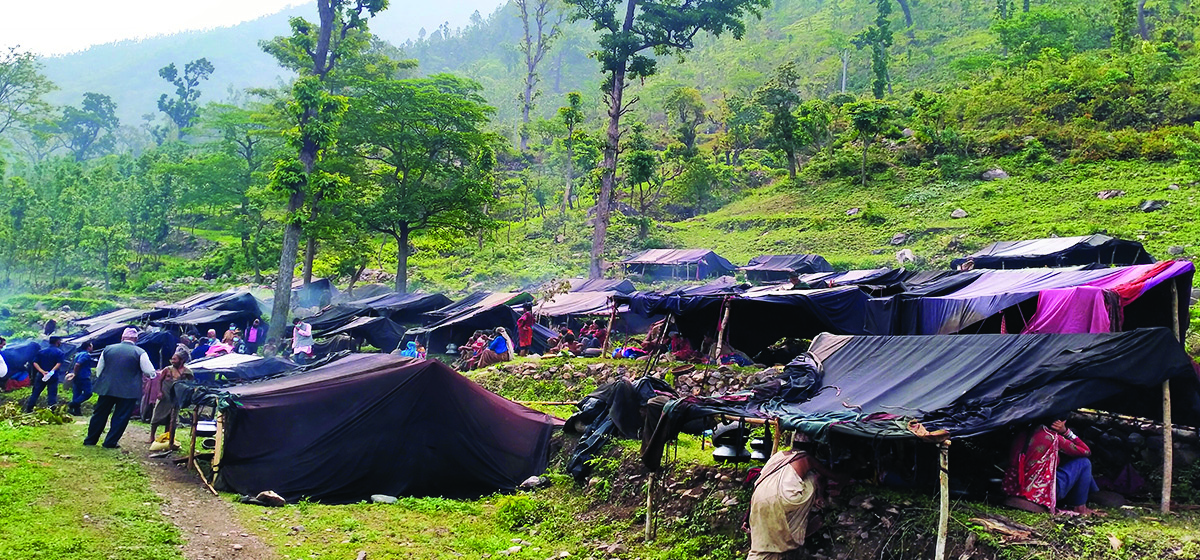 A Raute camp of dark tents pitched in a forest clearing; the whole settlement moves when the community moves.