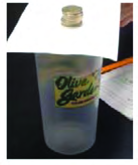 When the card is pulled away suddenly, the coin at rest tries to stay where it is and drops straight into the glass.