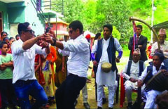 Guests dance to drum beats as a wedding procession passes through the village.
