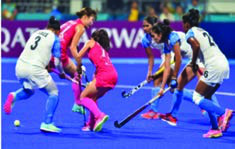 Field hockey: players use curved sticks to push a small ball toward the goal.