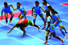 Kabaddi: a raider touches opponents and tries to return to his own half without being caught.