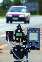 A radar speed gun. From the microwaves that bounce back off a moving vehicle, it measures how fast the vehicle is going.