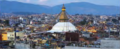 Kathmandu spreading in every direction around the white dome of the Boudhanath Stupa.