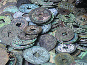 Early metal coins. Regulated coinage began in the kingdom of Lydia and spread across the ancient world.