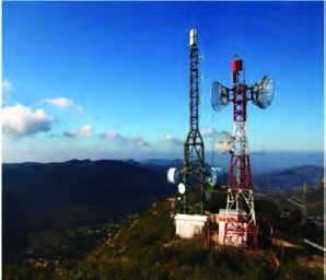 Towers on a hilltop receive and send telecommunication signals, which is how a mobile network reaches remote villages.