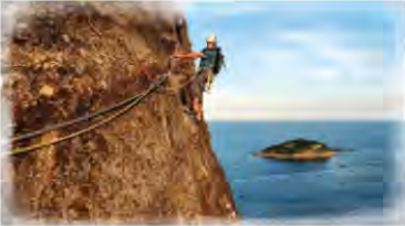 A climber on the rock face of Sugarloaf, high above the Atlantic Ocean