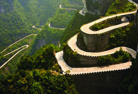 A winding mountain road with many sharp bends. A road like this is slow and hard to drive at night.