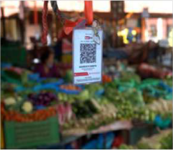 QR code in the market: a buyer scans it with a phone and the money goes to the seller's bank account.