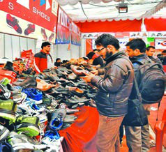 A busy shoe stall: customers request items with words like "Could you show me...?"
