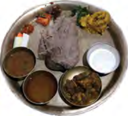 Dhido served with soup, meat curry, greens and pickle